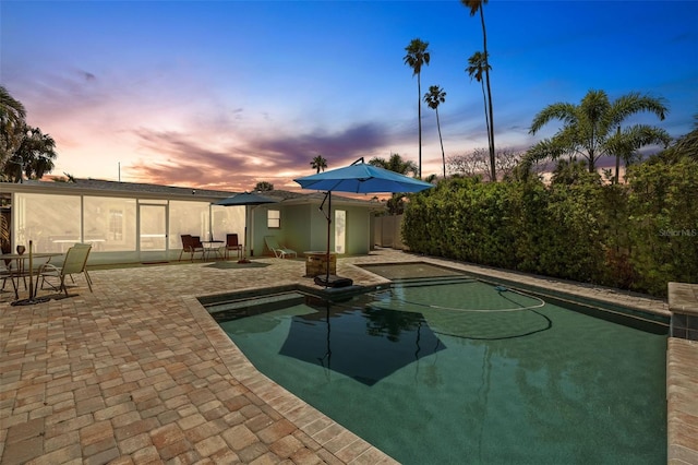 view of pool at dusk