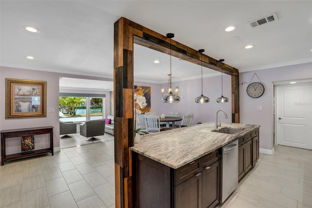 kitchen featuring sink, stainless steel dishwasher, light stone countertops, decorative light fixtures, and dark brown cabinetry