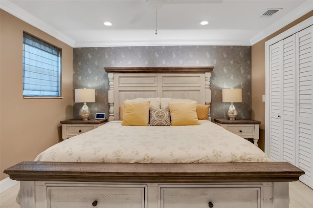 bedroom with a closet, ceiling fan, and crown molding