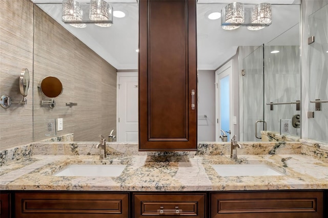 bathroom with a shower with door and vanity