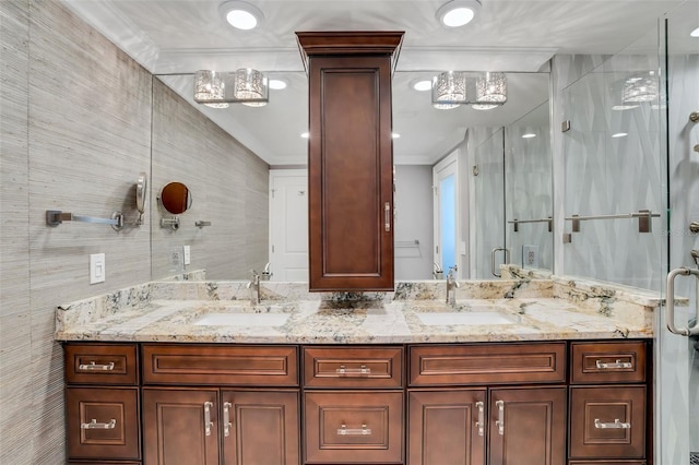 bathroom with ornamental molding, vanity, tile walls, and a shower with shower door