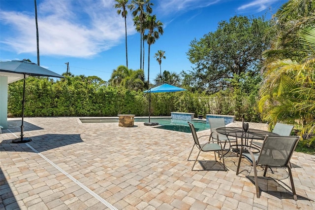 view of patio / terrace with a pool with hot tub