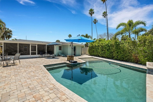 view of swimming pool featuring a patio and a sunroom