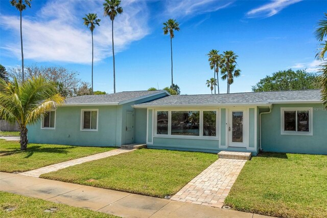 ranch-style home featuring a front yard