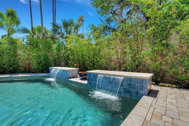 view of swimming pool with pool water feature