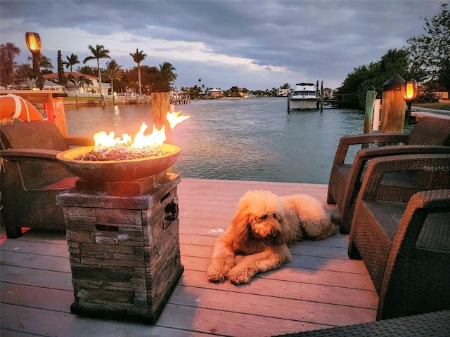 view of dock featuring a water view and an outdoor fire pit