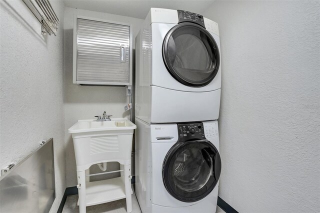 laundry area with stacked washer / dryer