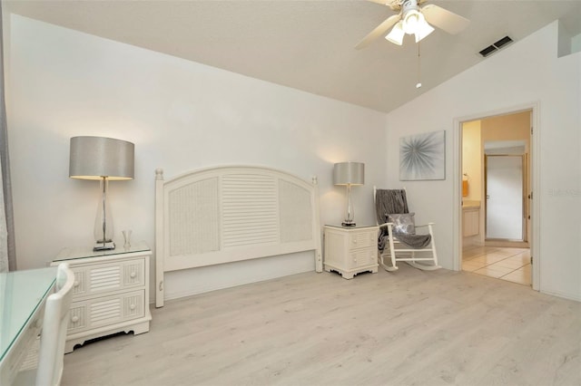 home office with vaulted ceiling, ceiling fan, and light hardwood / wood-style flooring