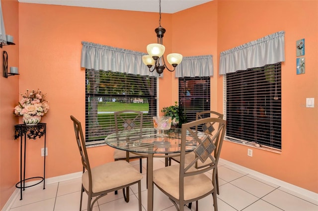 tiled dining space featuring an inviting chandelier