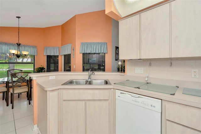 kitchen featuring light brown cabinetry, kitchen peninsula, sink, and white dishwasher