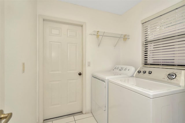 washroom with washer and clothes dryer and light tile patterned floors