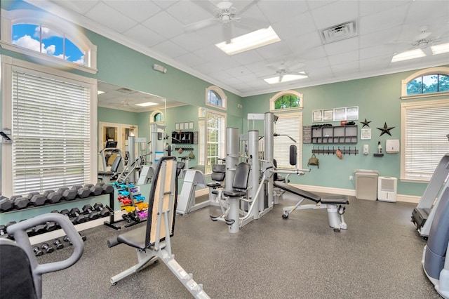 workout area featuring a wealth of natural light, ceiling fan, and crown molding