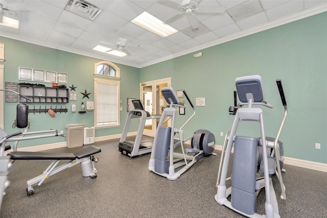 workout area with ornamental molding, a paneled ceiling, and ceiling fan