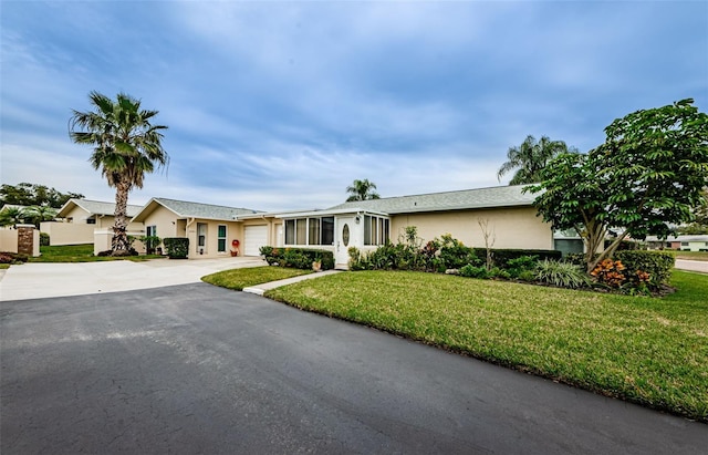 single story home with a front lawn and a garage