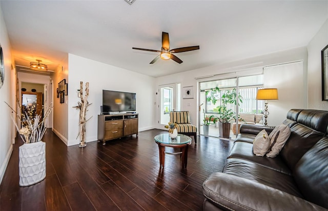 living room with ceiling fan and dark hardwood / wood-style floors