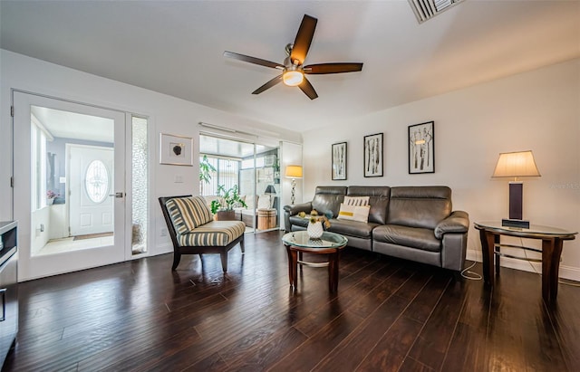 living room with ceiling fan and dark hardwood / wood-style flooring