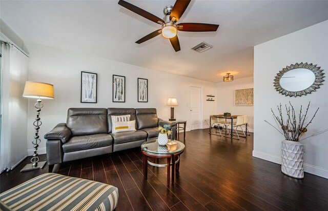 living room featuring ceiling fan and dark hardwood / wood-style floors