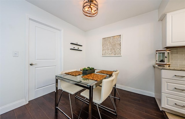 dining room with dark hardwood / wood-style floors