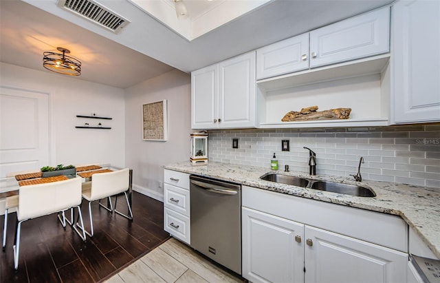 kitchen with white cabinetry, sink, light hardwood / wood-style flooring, and dishwasher