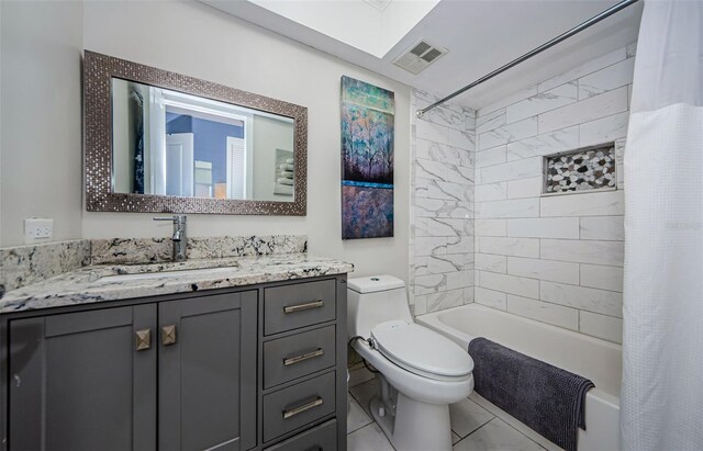 full bathroom featuring vanity, tile patterned floors, toilet, and shower / tub combo