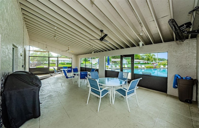 sunroom / solarium featuring ceiling fan and vaulted ceiling