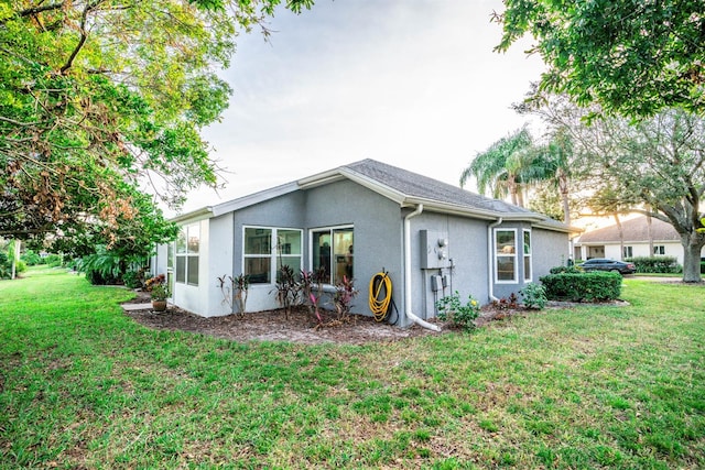 rear view of property with a lawn