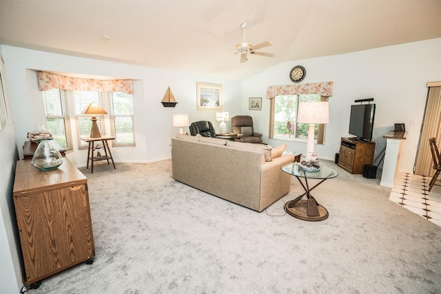 living room with ceiling fan, light colored carpet, and lofted ceiling