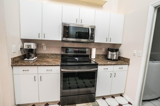 kitchen featuring stainless steel appliances, dark stone counters, decorative backsplash, and white cabinets