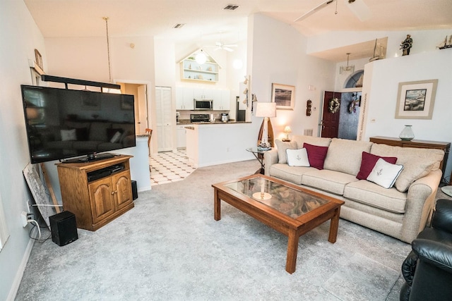 carpeted living room featuring high vaulted ceiling and ceiling fan