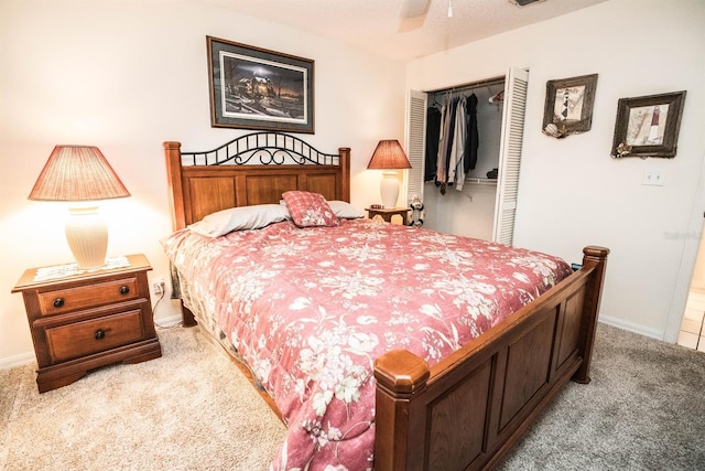 carpeted bedroom with ceiling fan and a closet