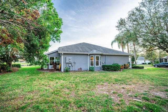 back of house featuring a lawn