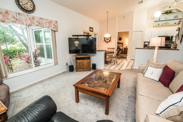 living room featuring vaulted ceiling and carpet floors