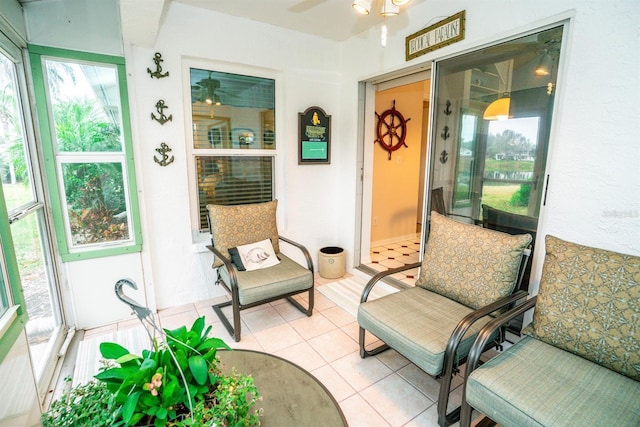 sunroom featuring ceiling fan