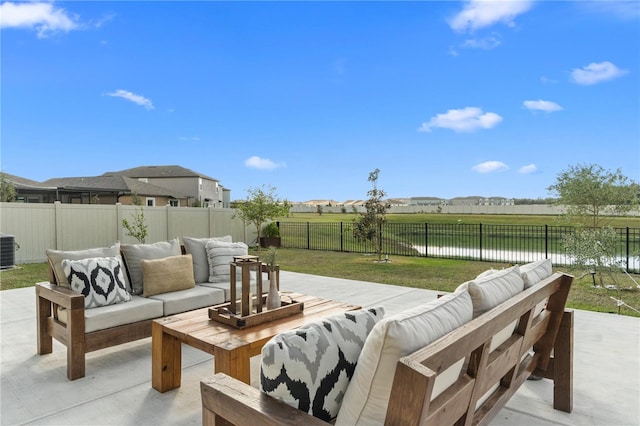 view of patio / terrace with an outdoor living space, cooling unit, and a water view