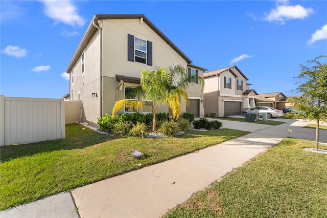 view of front of home with a garage and a front lawn