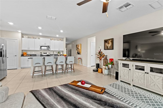 tiled living room with ceiling fan