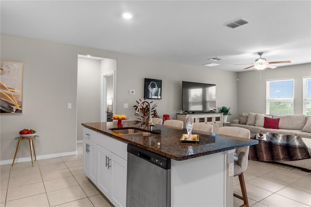 kitchen featuring a kitchen island with sink, sink, white cabinets, and stainless steel dishwasher