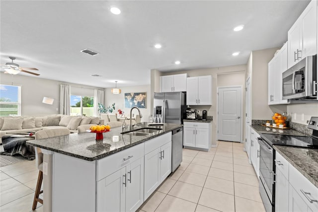 kitchen with white cabinetry, sink, a center island with sink, and appliances with stainless steel finishes