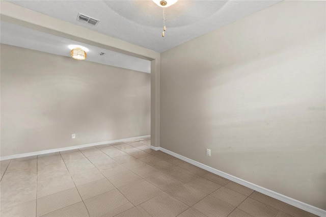 spare room featuring light tile patterned flooring