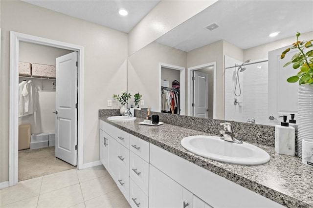 bathroom with tile patterned floors, vanity, and walk in shower