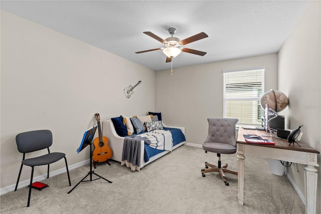 carpeted bedroom featuring a textured ceiling and ceiling fan