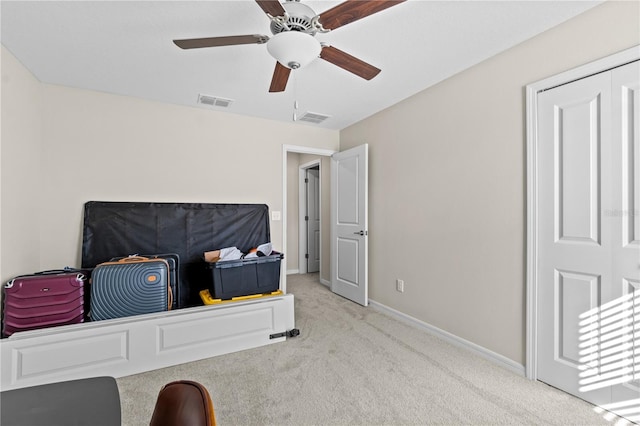 bedroom with ceiling fan, a closet, and light carpet