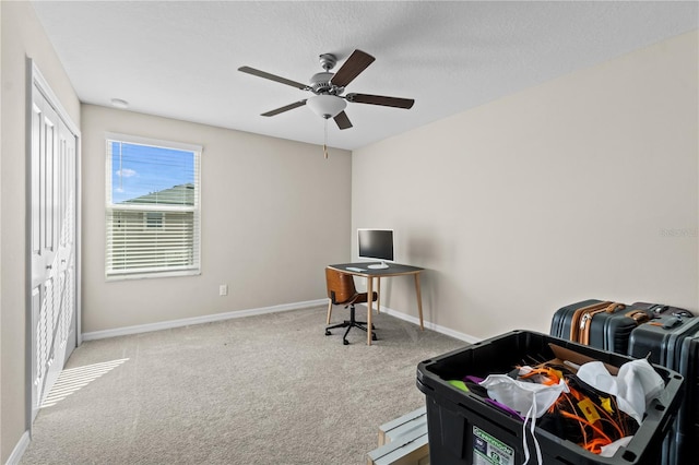 carpeted bedroom featuring ceiling fan and a textured ceiling