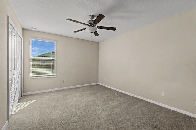 unfurnished bedroom featuring ceiling fan, a closet, and light colored carpet