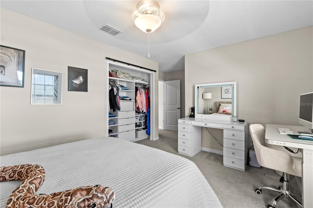 bedroom with light colored carpet and a closet