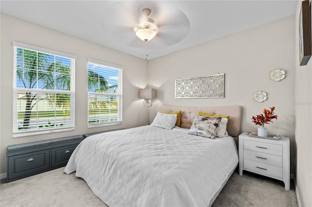 bedroom with ceiling fan and light carpet