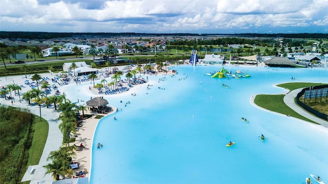 bird's eye view featuring a water view and a beach view