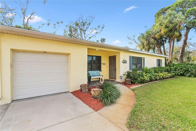 single story home with a garage and a front lawn