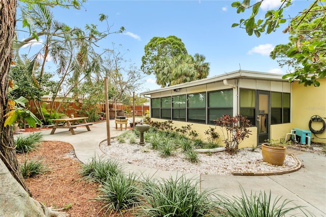 exterior space featuring a patio and a sunroom