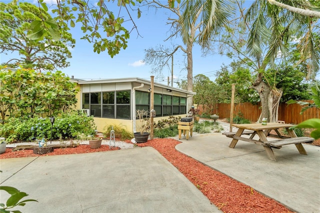 view of patio featuring a sunroom